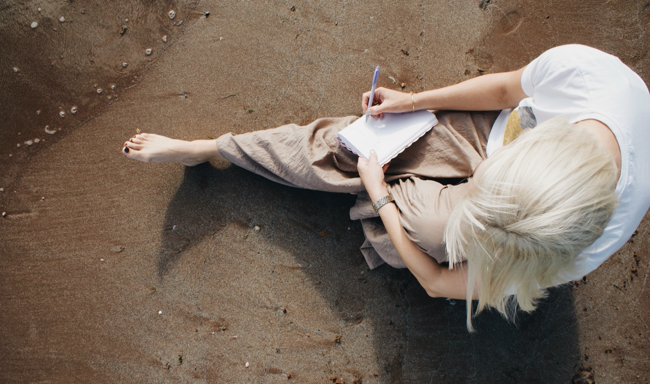 thought provoking journaling on the beach near The Space
